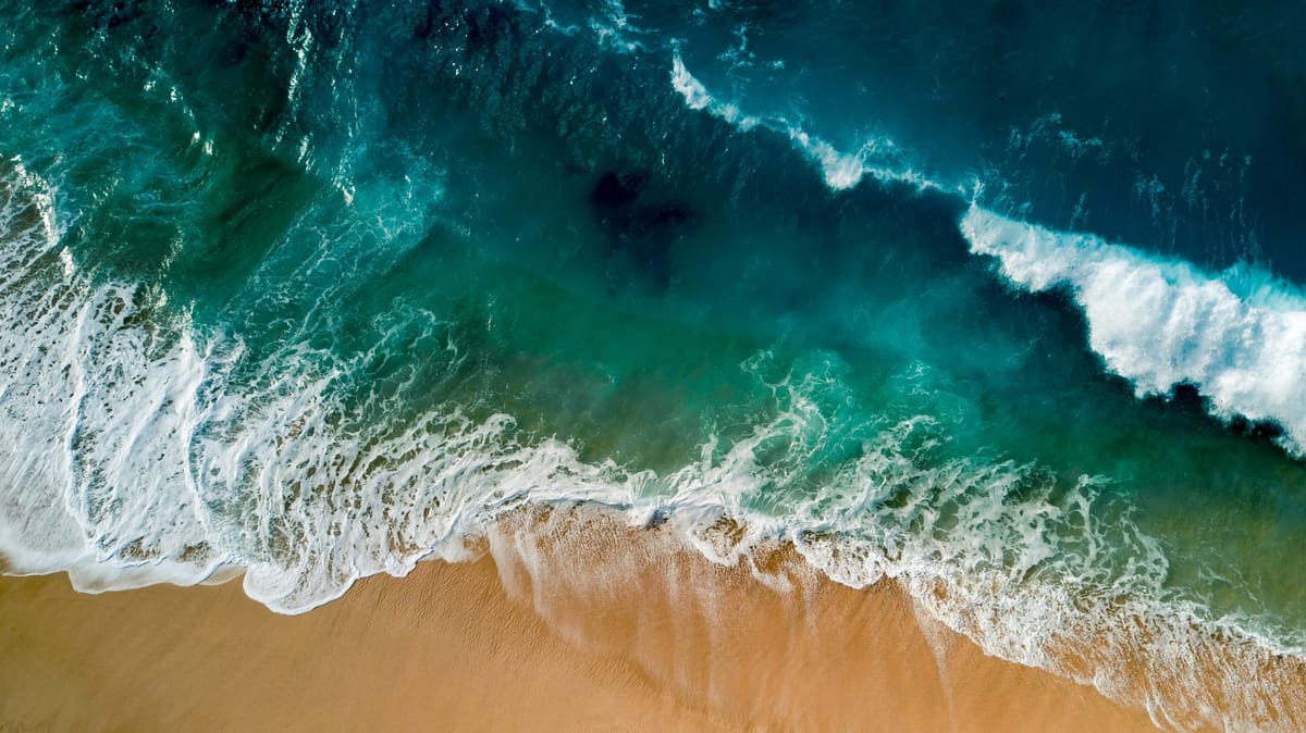sea waves on brown shore at daytime